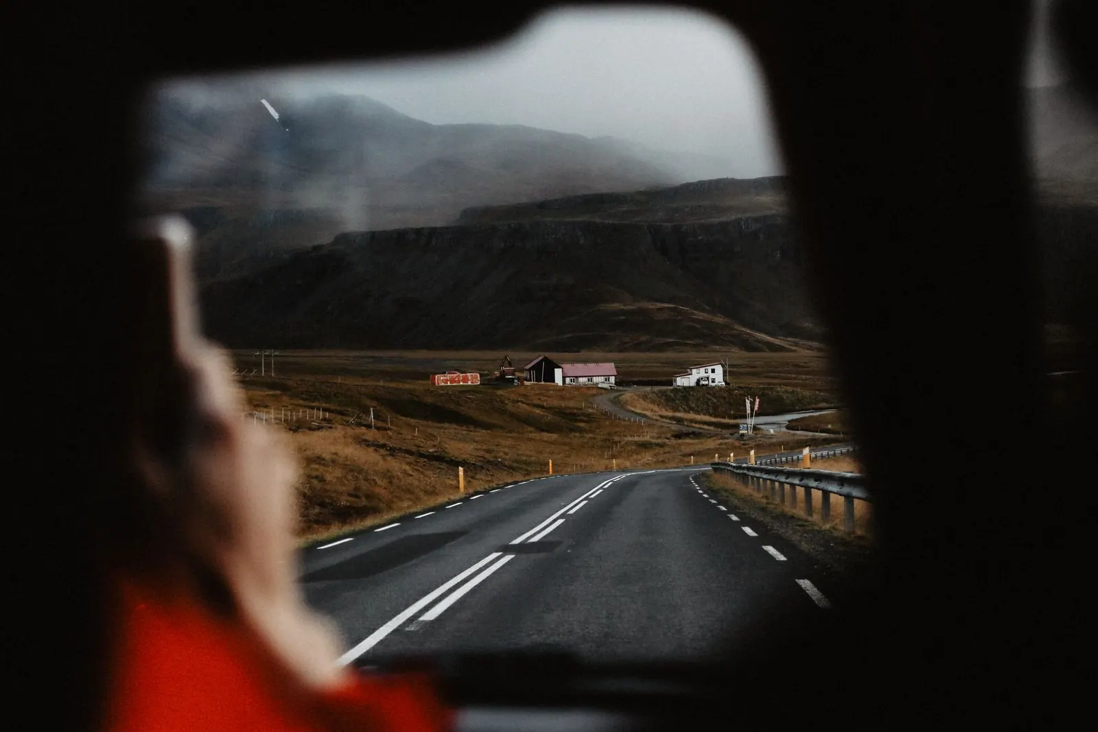 An open country road seen through a car windscreen